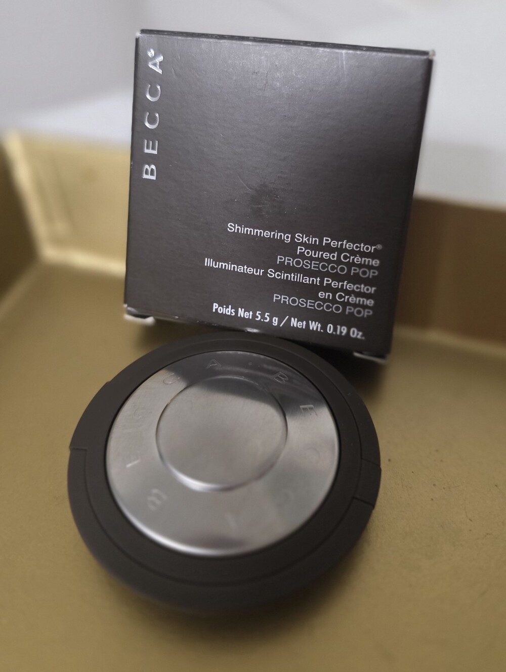 BECCA Shimmering Skin Perfector Poured Crème - Prosecco Pop in Black and Silver